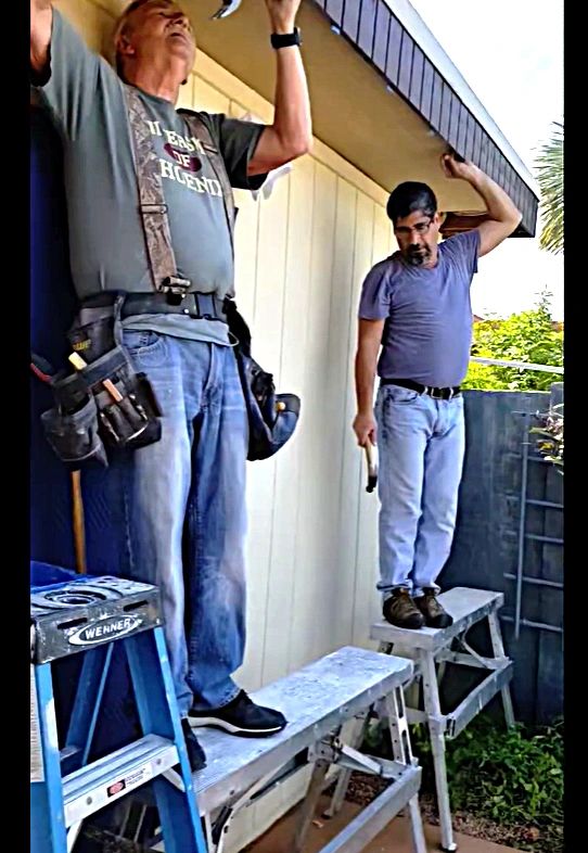John and Joe working on exterior of home