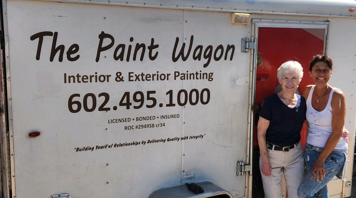 The Paint Wagon LLC team — Leni and Toni in front of the work trailer
